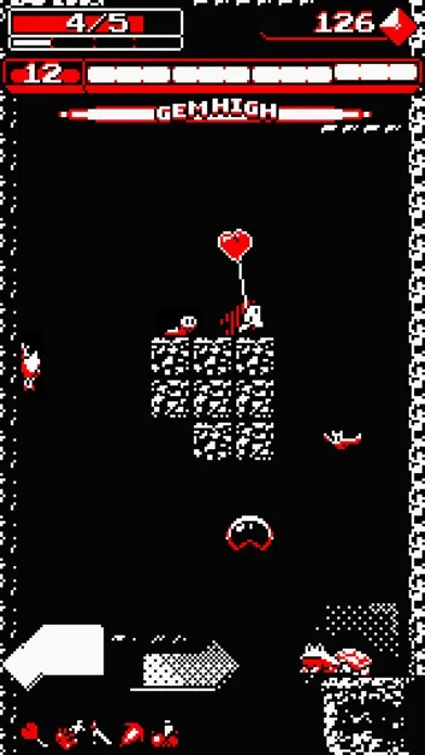 Schermata di Downwell in bianco, nero e rosso: le barre di energia e di munizioni in alto, il personaggio a metà pozzo fra piattaforme e nemici.
